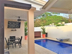 Dining table of four with LED TV, next to pool