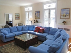 Bright, sunny, spacious living room with windows facing deck