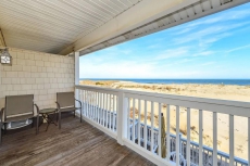 Spacious, traditional 3 bedroom oceanfront townhouse with WiFi, a large covered deck, balcony access from multiple rooms, and amazing view of ocean located uptown in family-friendly neighborhood and mere steps to beach!