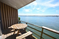 Upscale, relaxing 1 bedroom bayfront condo with free WiFi, a smart TV, and a pier directly over the bay located downtown and just a few blocks from the beach!